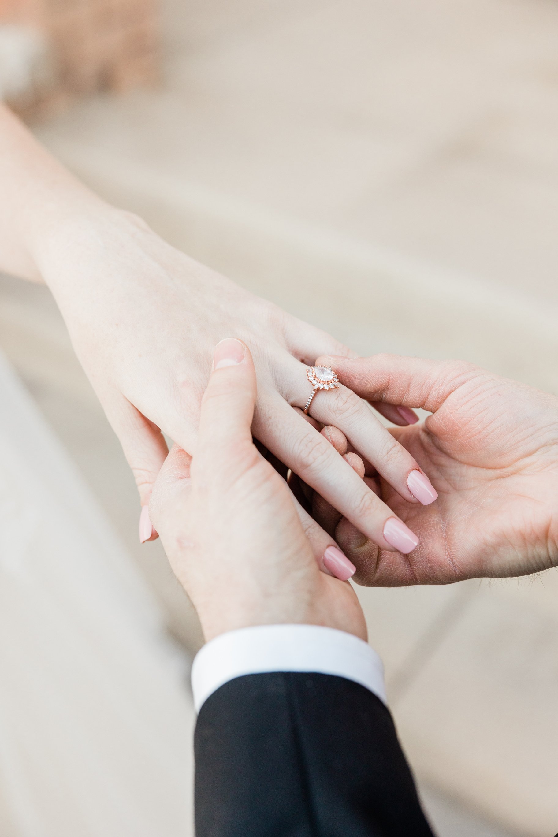 Groom Putting on Ring on Bride's Finger